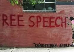 Graffiti on wall: "Free Speech, Conditions Apply.
