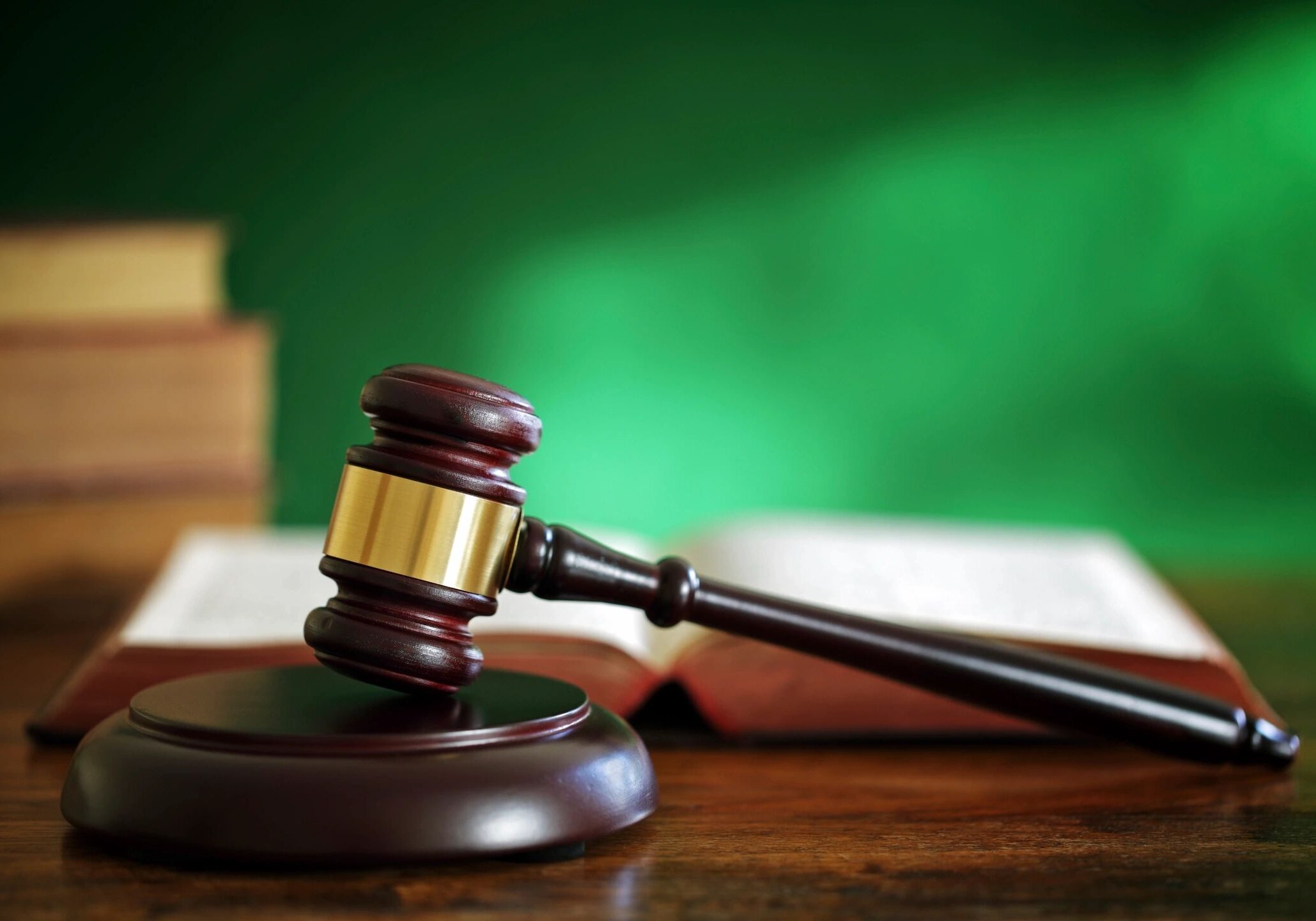 Gavel and open book on table.