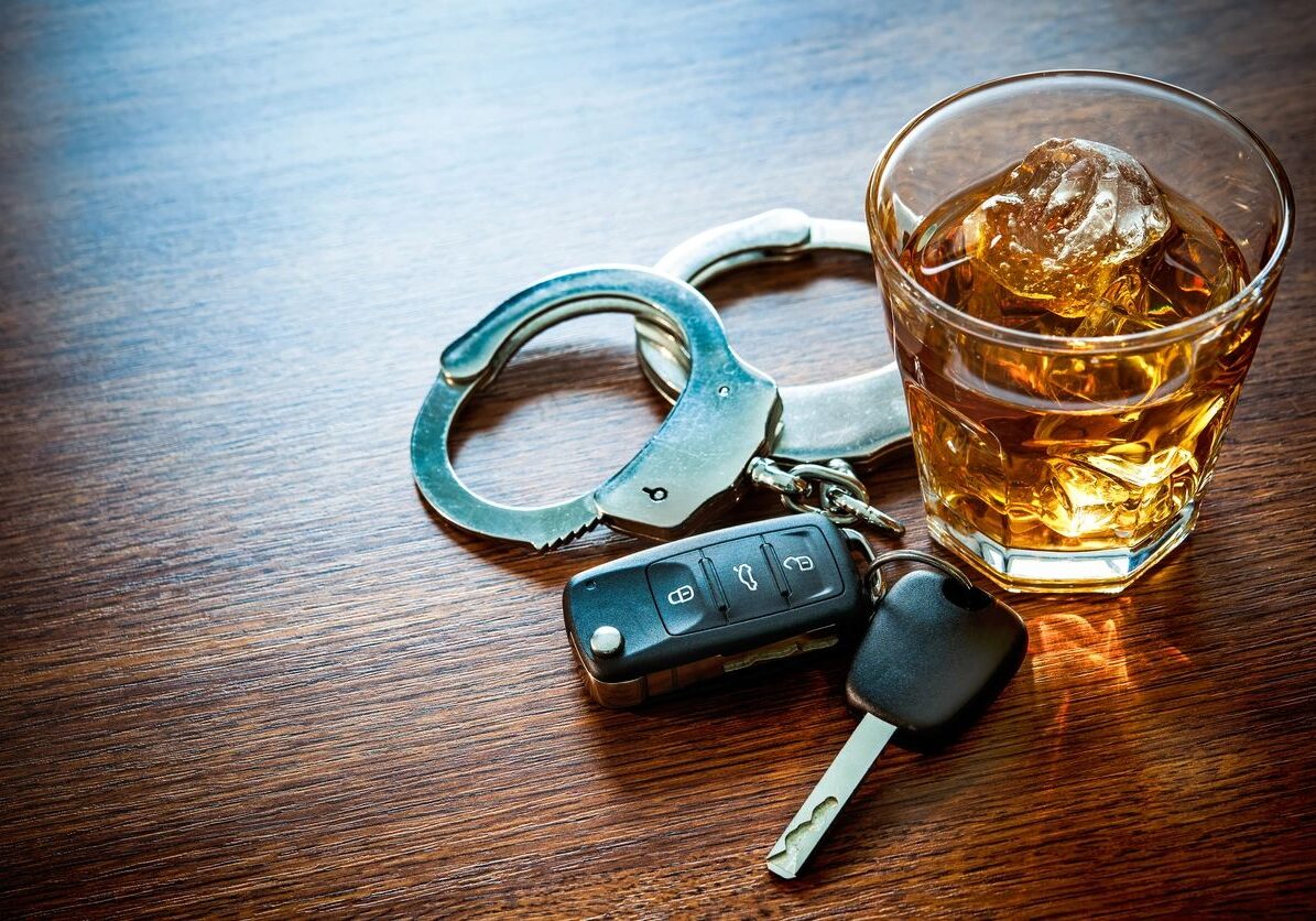 Handcuffs, car keys, and whiskey glass.