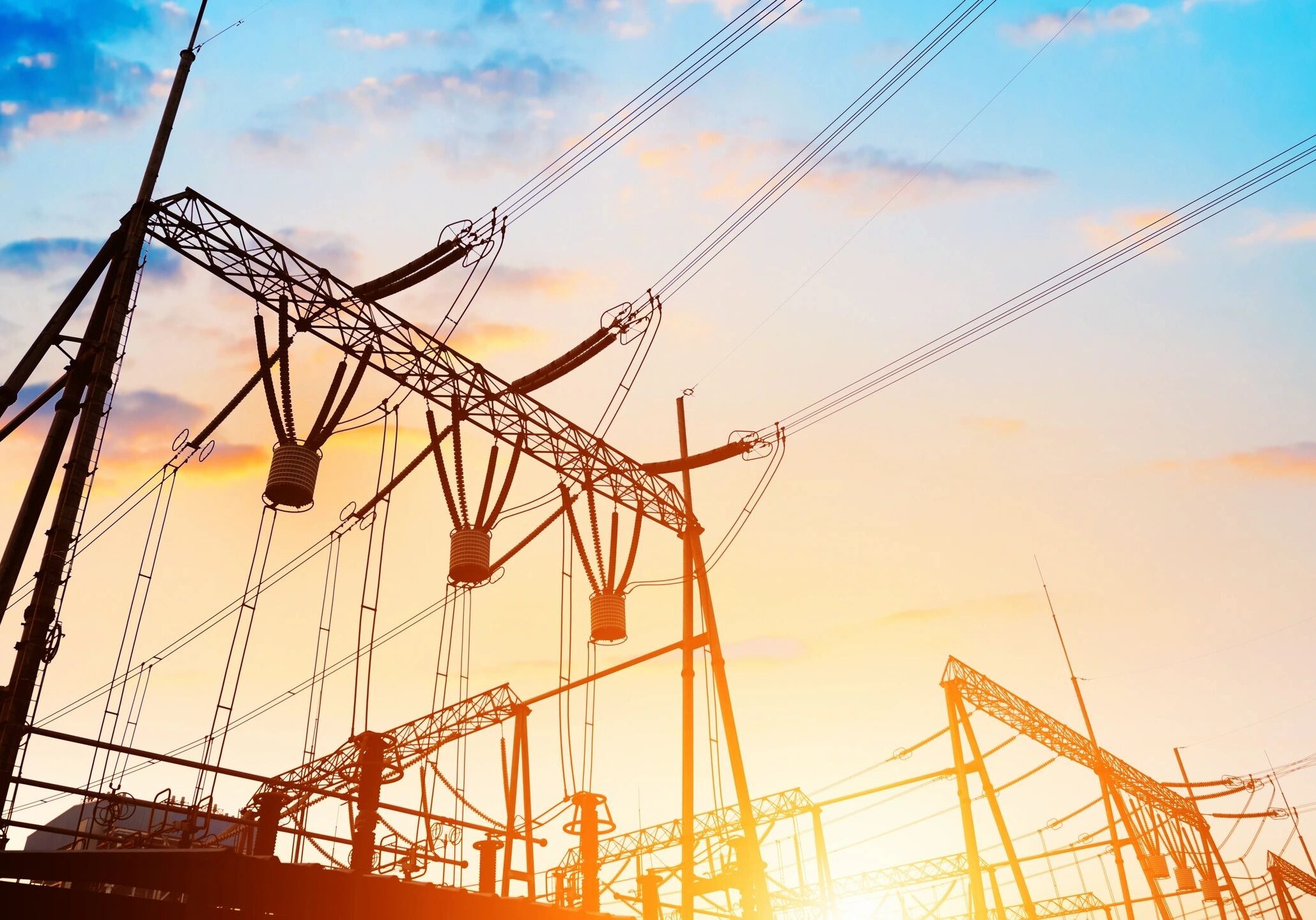 Power lines at sunset with colorful sky.