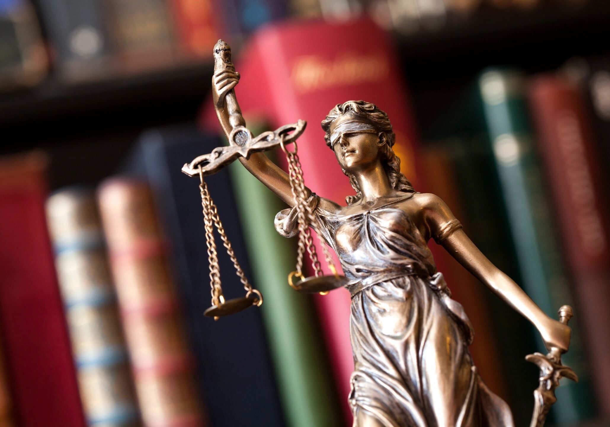 Lady Justice statue with scales and books.