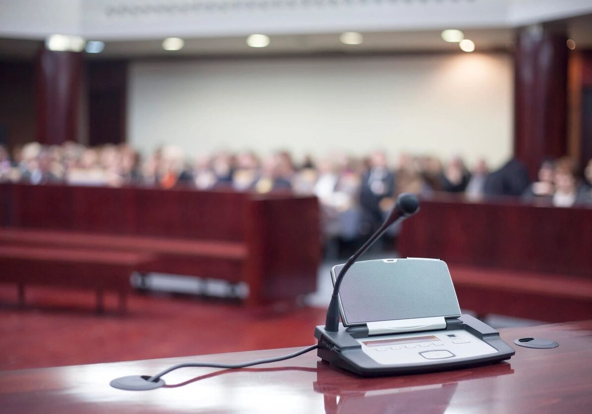 Microphone on podium in a conference room.