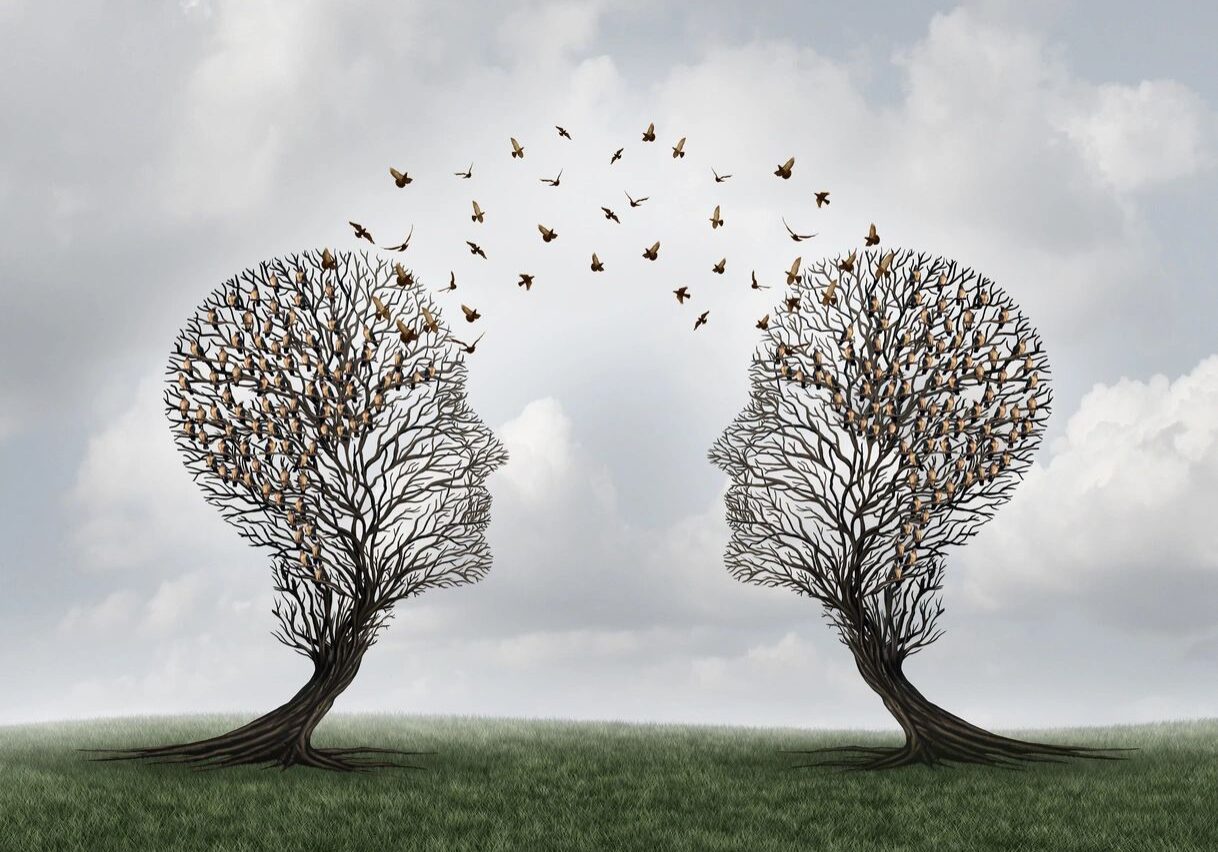 Two tree heads sharing flying birds.