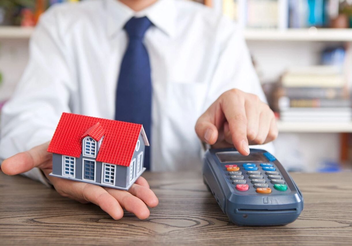 Mini house and card reader on table.